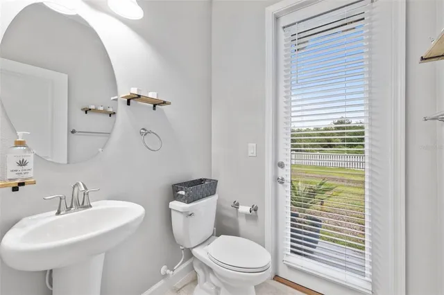 an aerial view of a house with garden space and a patio