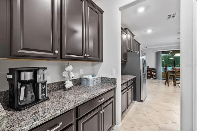 a kitchen with granite countertop stainless steel appliances and wooden cabinets
