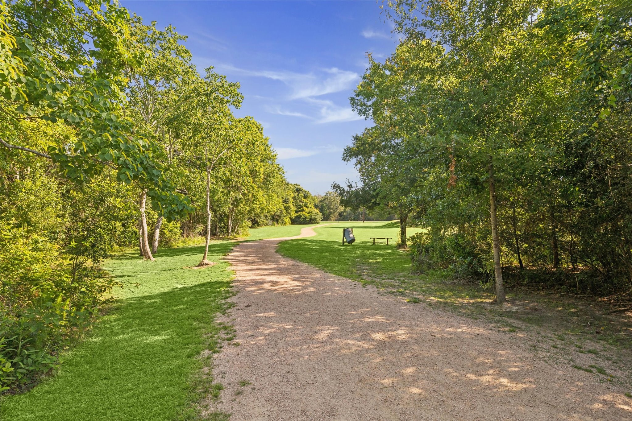 0 Hester Street Seabrook, TX 77586 - Photo 10 of 16 This photo features a scenic, tree-lined pathway in a park-like setting, perfect for walking or jogging. The lush greenery and open space create a serene and inviting atmosphere.