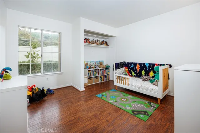 a bedroom with furniture and a wooden floor