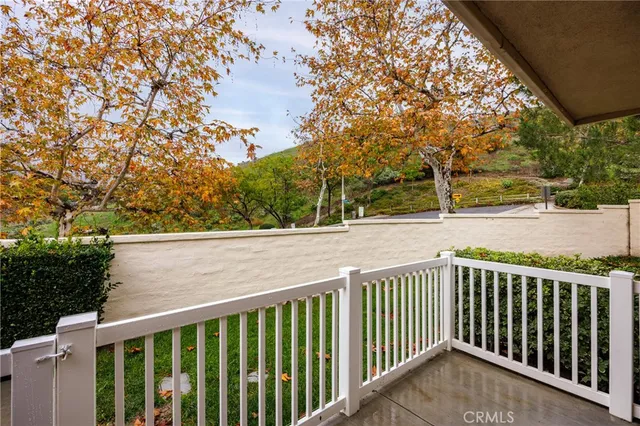 a view of balcony with wooden floor and fence