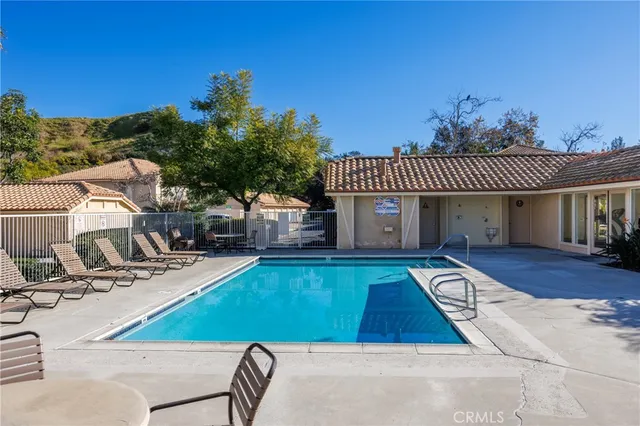 a view of a house with swimming pool and sitting area