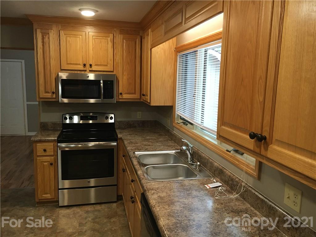 21 Sitton Road Sylva, NC 28779 - Photo 4 of 16 a kitchen with a sink and a stove top oven