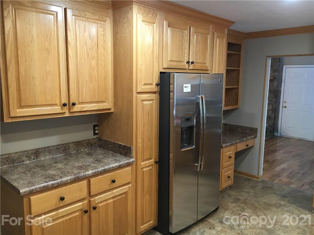 21 Sitton Road Sylva, NC 28779 - Photo 5 of 16 a kitchen with granite countertop a refrigerator and cabinets