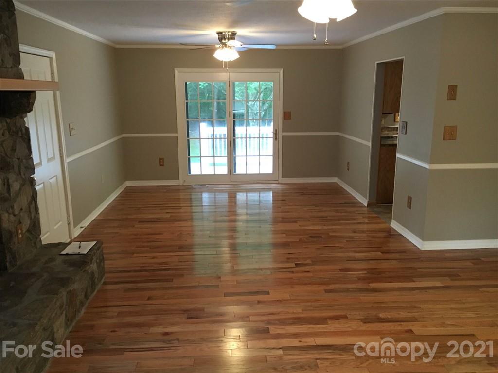21 Sitton Road Sylva, NC 28779 - Photo 7 of 16 a view of empty room with wooden floor and fan