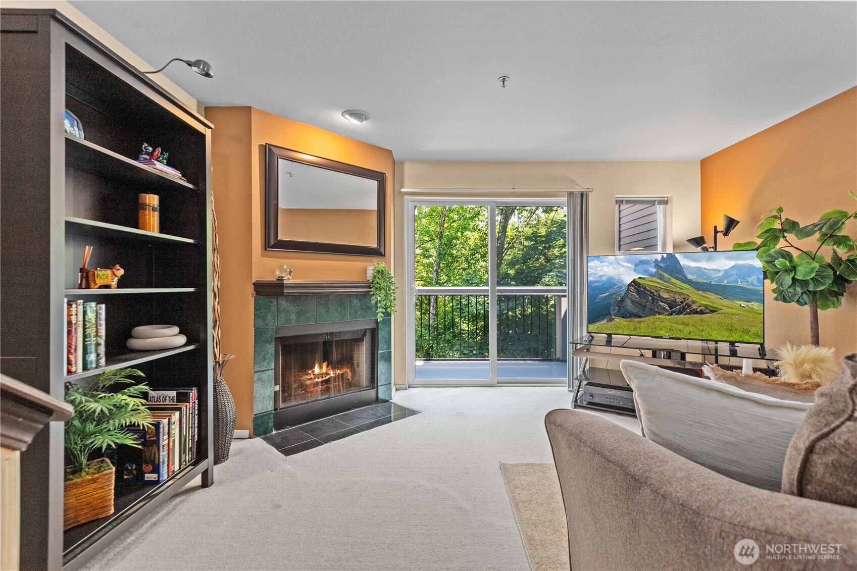 16019 Waynita Way Northeast, Unit F207 Bothell, WA 98011 - Photo 11 of 39 a living room with furniture a fireplace and a flat screen tv