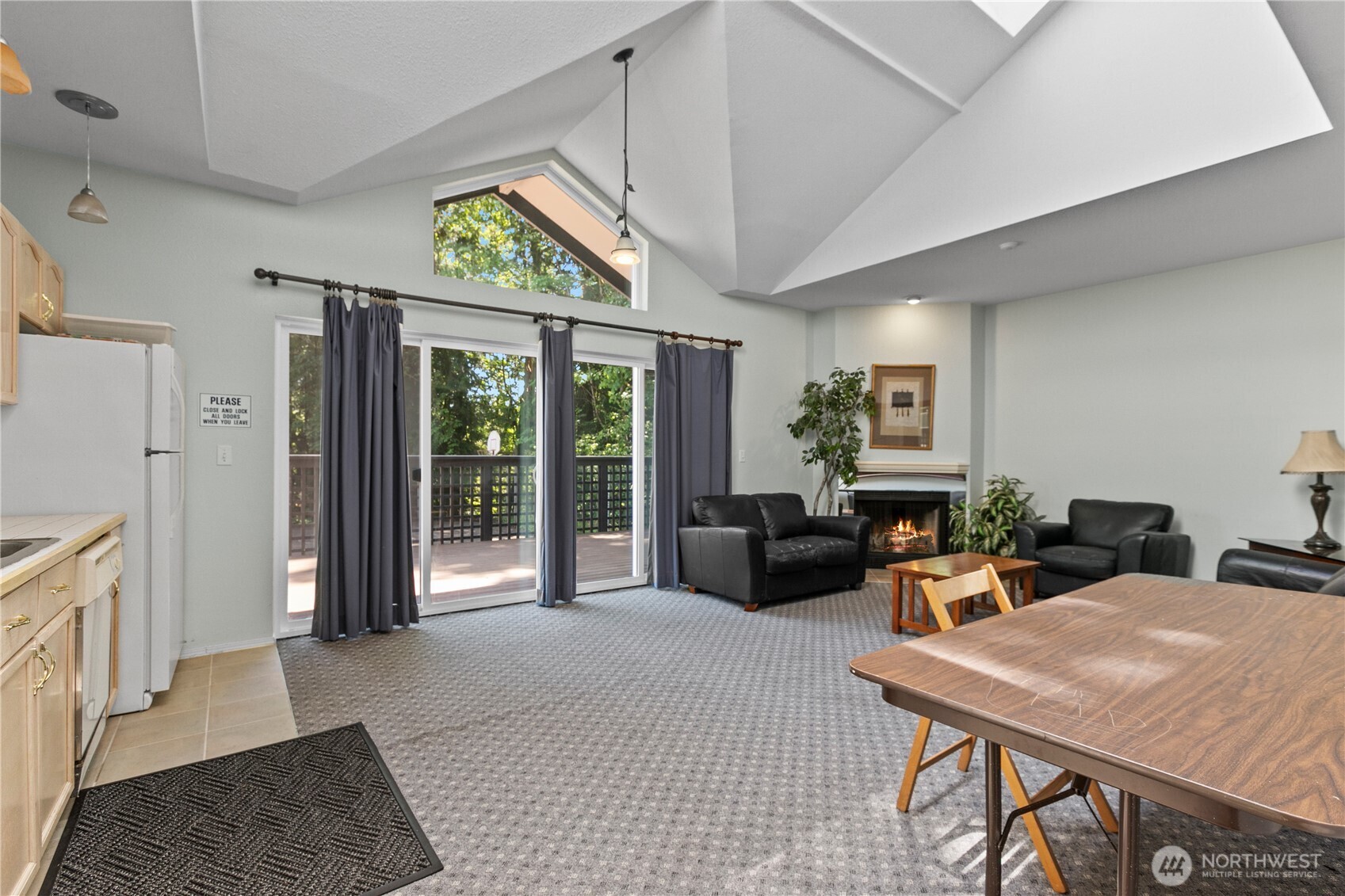 16019 Waynita Way Northeast, Unit F207 Bothell, WA 98011 - Photo 30 of 39 a living room with furniture a fireplace and a table