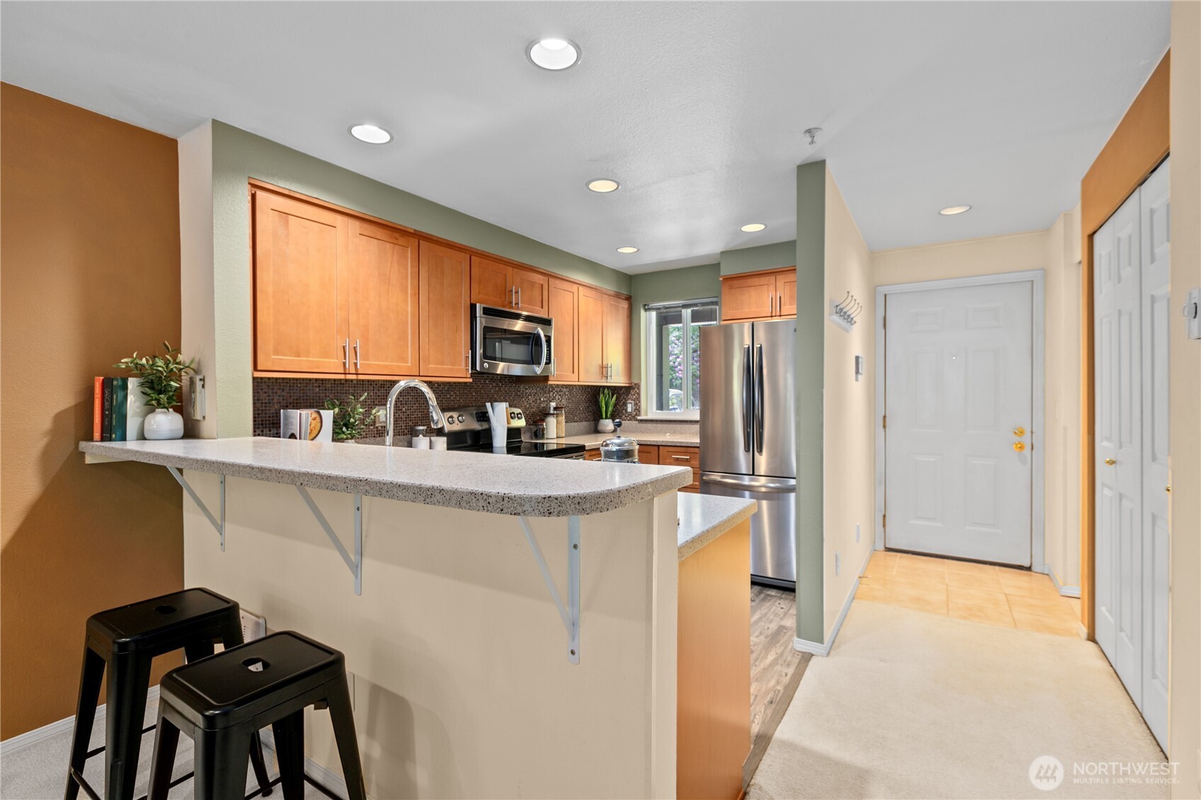 16019 Waynita Way Northeast, Unit F207 Bothell, WA 98011 - Photo 3 of 39 a kitchen with stainless steel appliances granite countertop sink refrigerator and window
