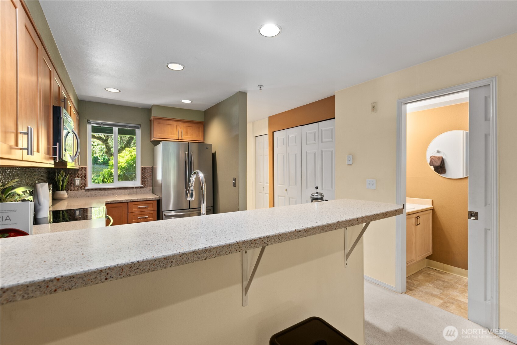 16019 Waynita Way Northeast, Unit F207 Bothell, WA 98011 - Photo 7 of 39 a kitchen with stainless steel appliances granite countertop a refrigerator and a sink