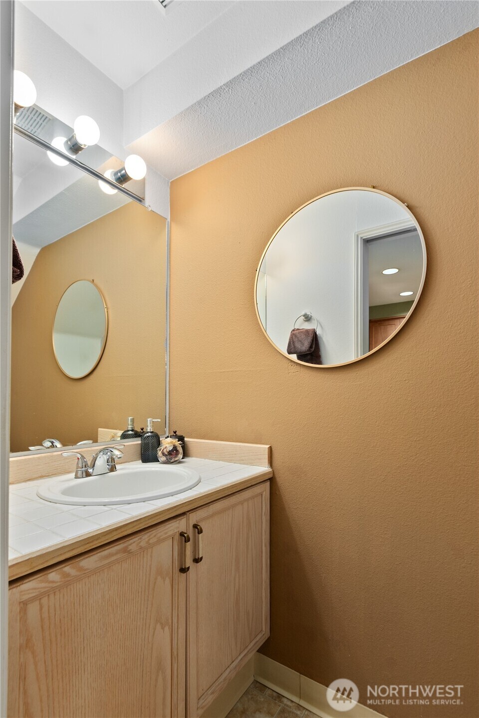 16019 Waynita Way Northeast, Unit F207 Bothell, WA 98011 - Photo 8 of 39 a bathroom with a sink mirror and vanity
