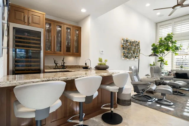 a kitchen with a table chairs sink and cabinets