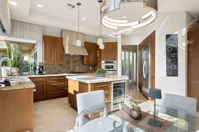 a kitchen with a sink cabinets and living room view
