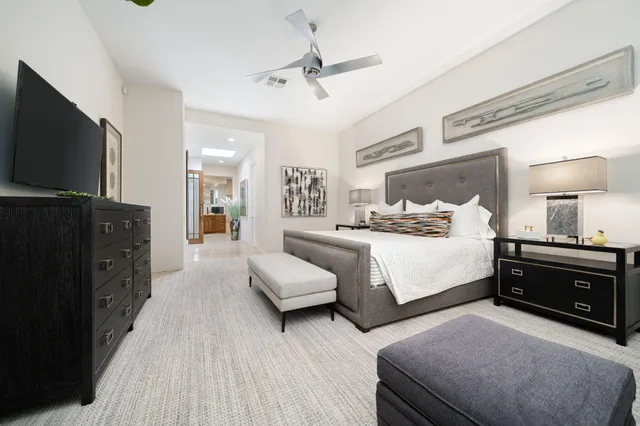 a bedroom with furniture and a flat screen tv