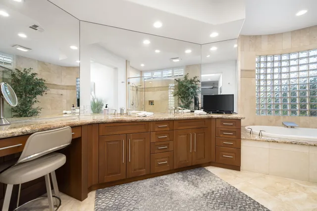 a large kitchen with kitchen island a sink stainless steel appliances and cabinets