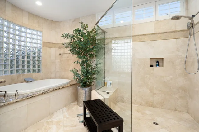 a bathroom with a bathtub and shower