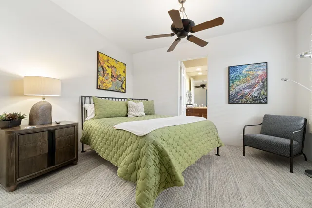 a bedroom with a bed and a couch