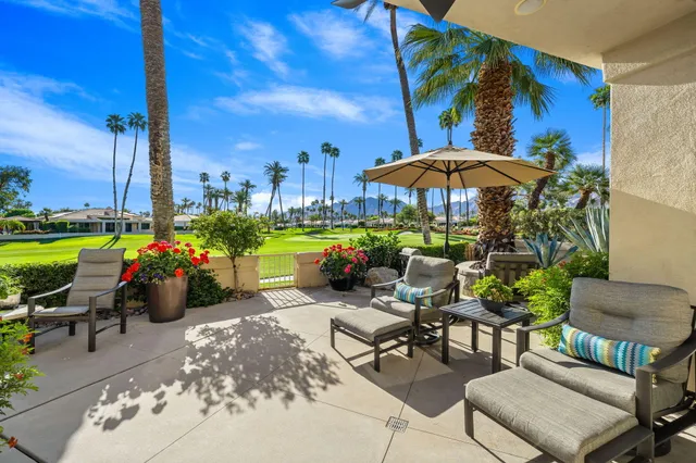 a view of a two chairs and table in the patio