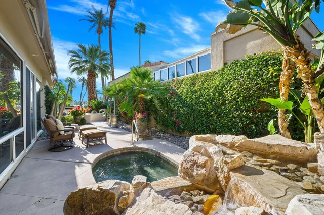 a view of backyard with outdoor seating and plants