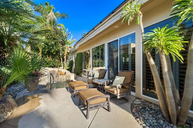 a backyard of a house with outdoor seating