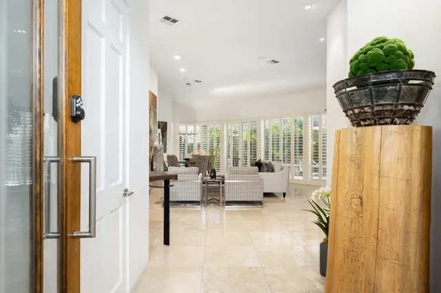a lobby with furniture and floor to ceiling window