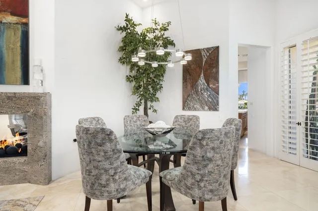 a view of a dining room with furniture and chandelier