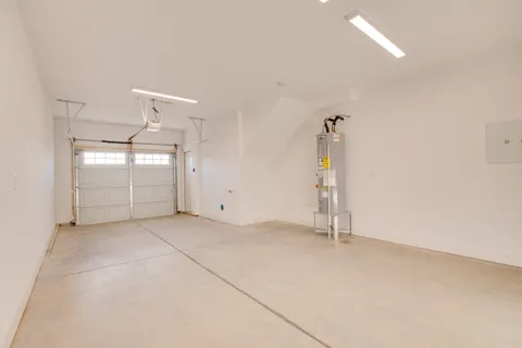 an empty room with windows and cabinet