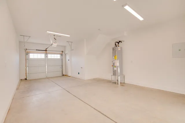 an empty room with windows and cabinet