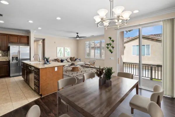 a view of a dining room with furniture a chandelier and wooden floor