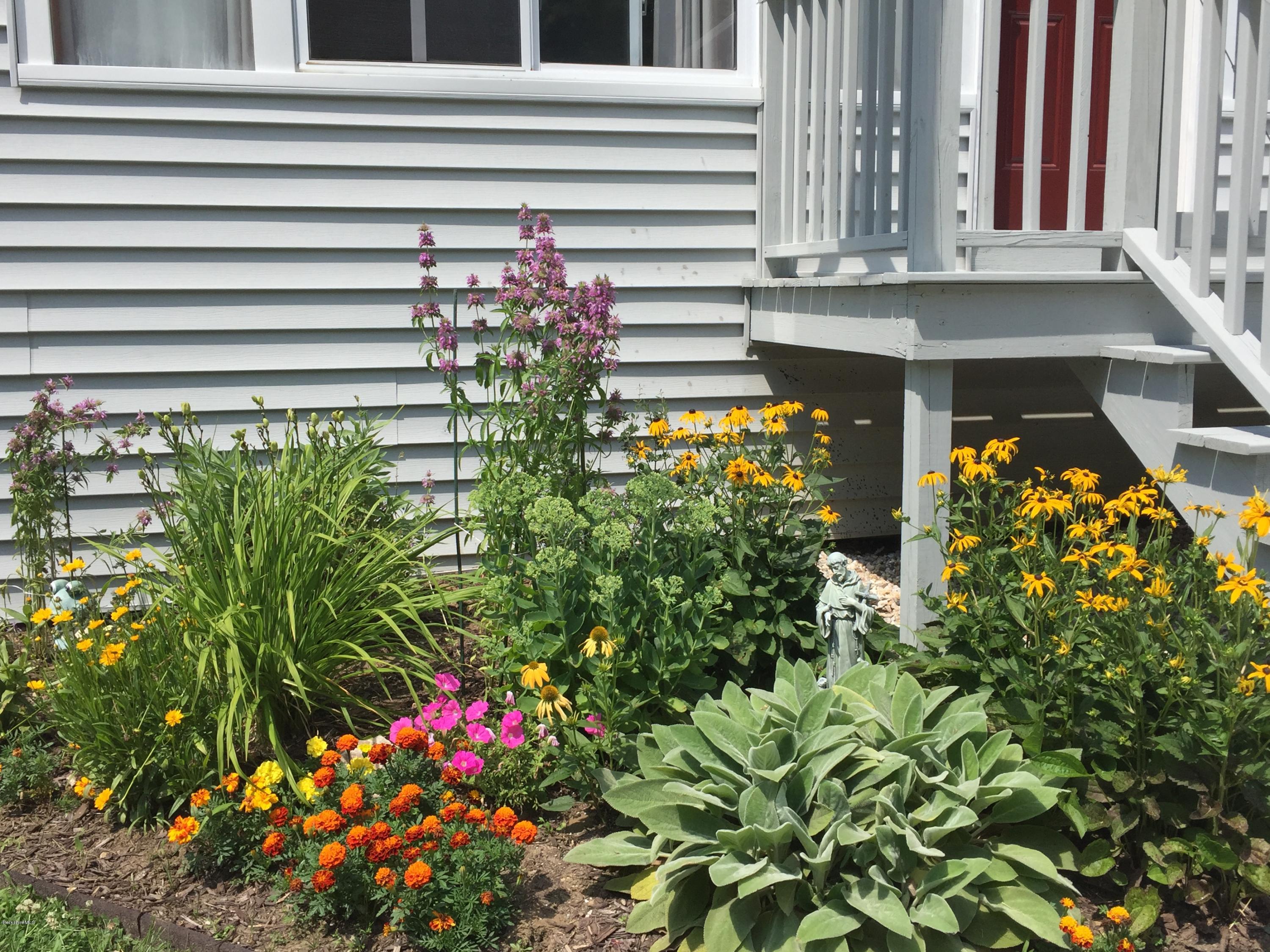 181 Bunce Road South Sheffield, MA 01222 - Photo 18 of 22 a picture of a house with a lot of flower plants