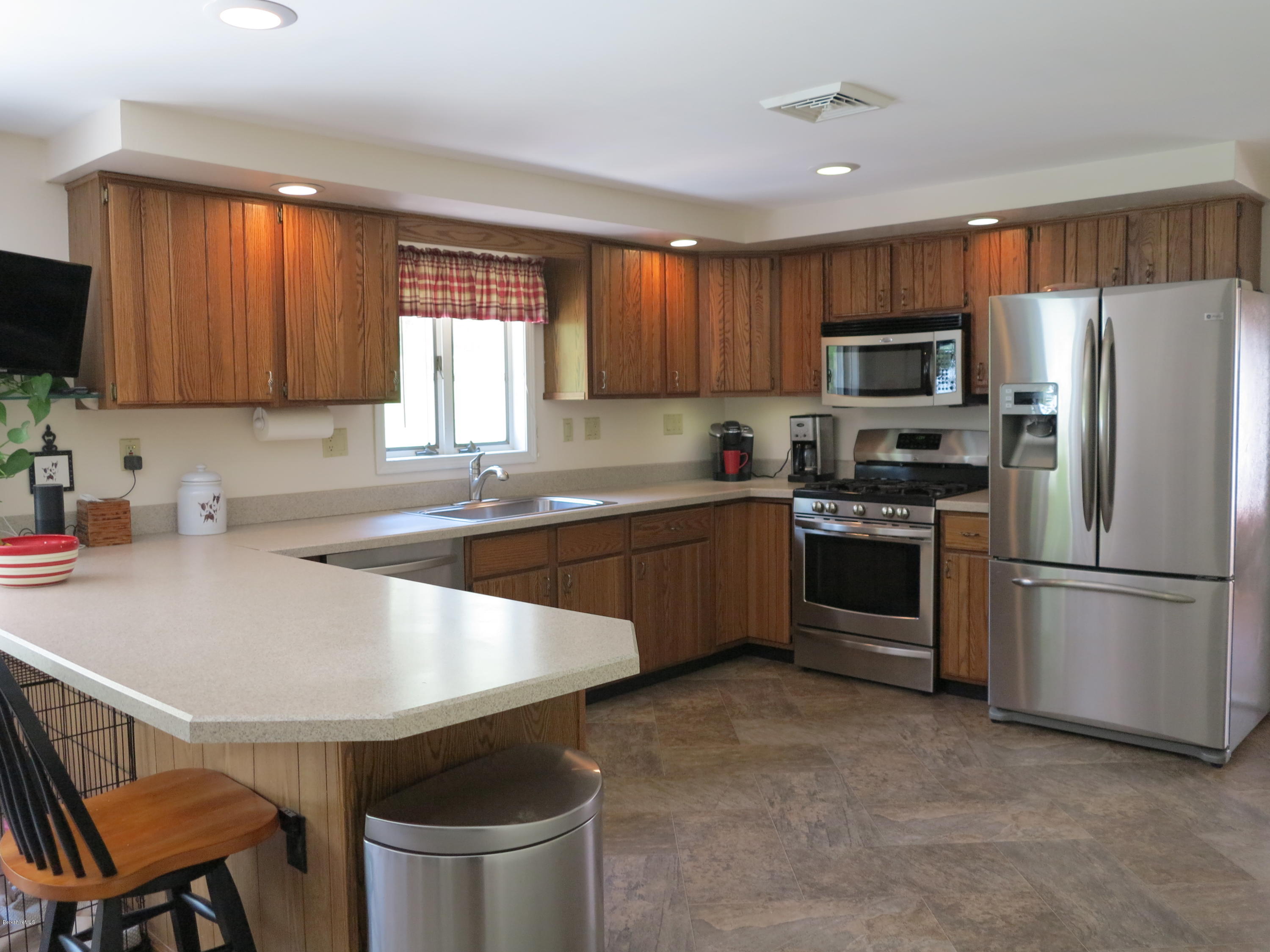 181 Bunce Road South Sheffield, MA 01222 - Photo 3 of 22 a kitchen with stainless steel appliances granite countertop a sink a stove a refrigerator cabinets and a window