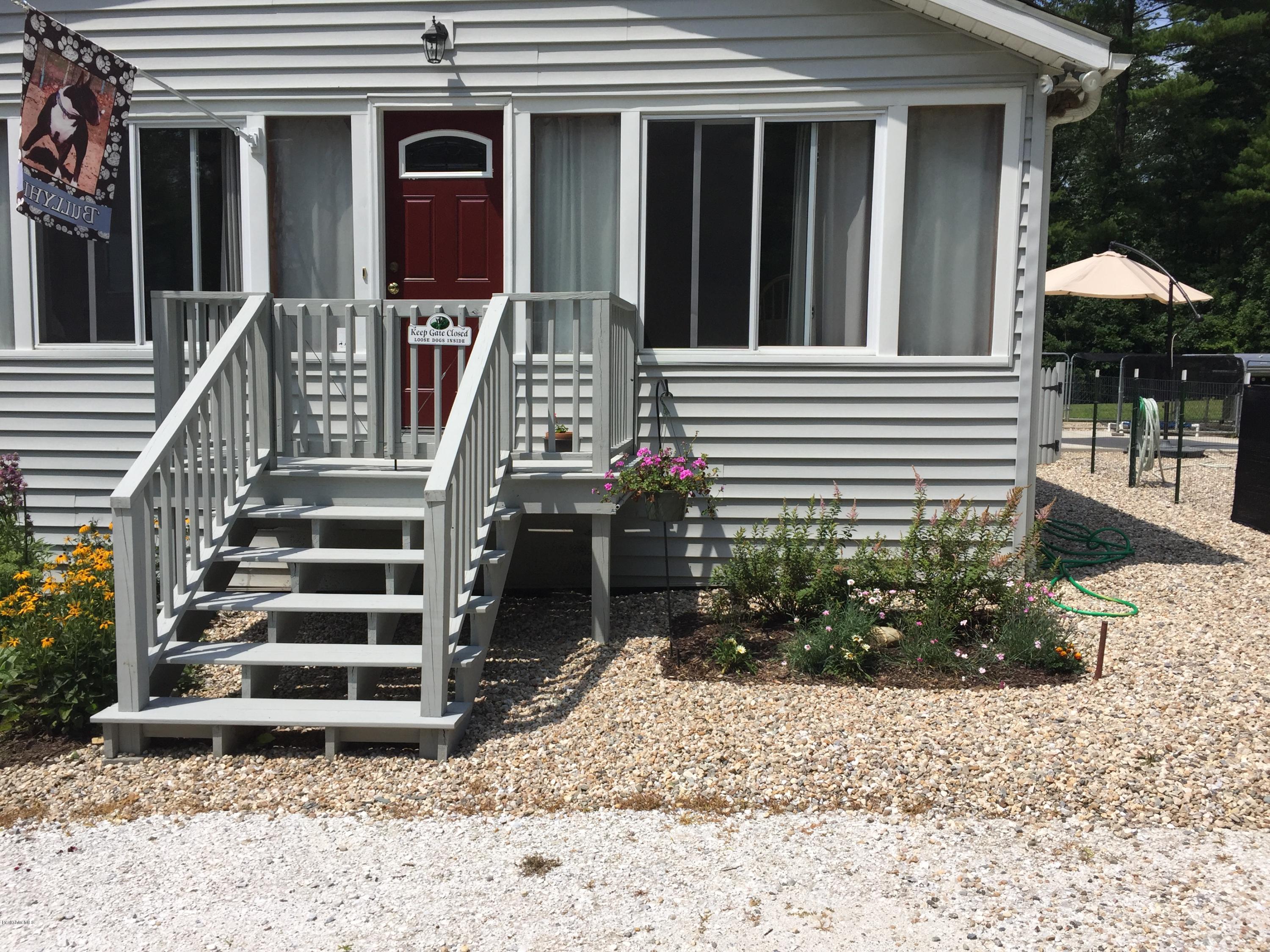 181 Bunce Road South Sheffield, MA 01222 - Photo 21 of 22 a view of a house with a yard and lawn chairs next to a yard