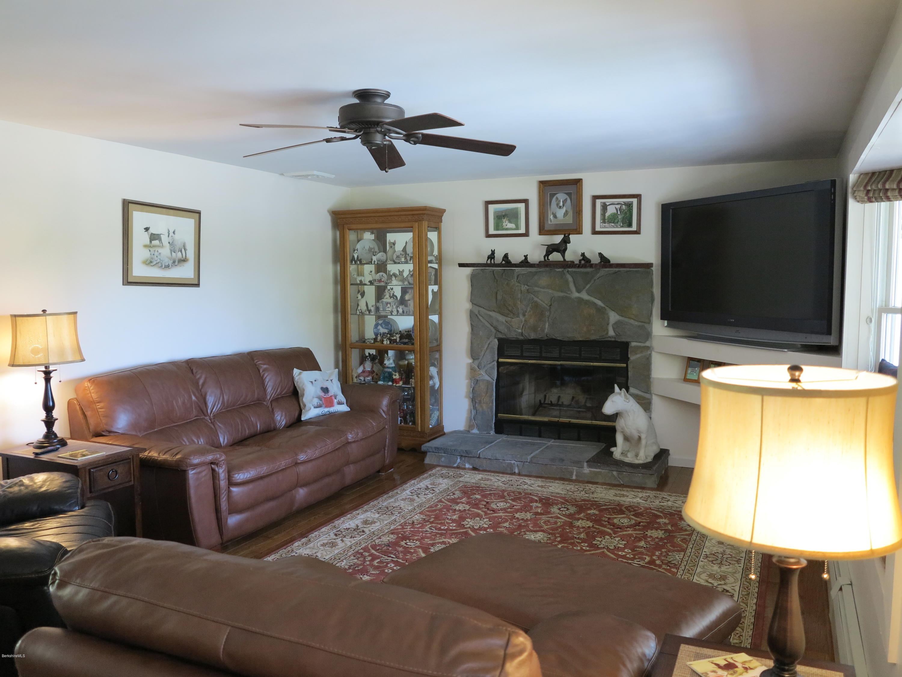 181 Bunce Road South Sheffield, MA 01222 - Photo 5 of 22 a living room with furniture a fireplace and a flat screen tv