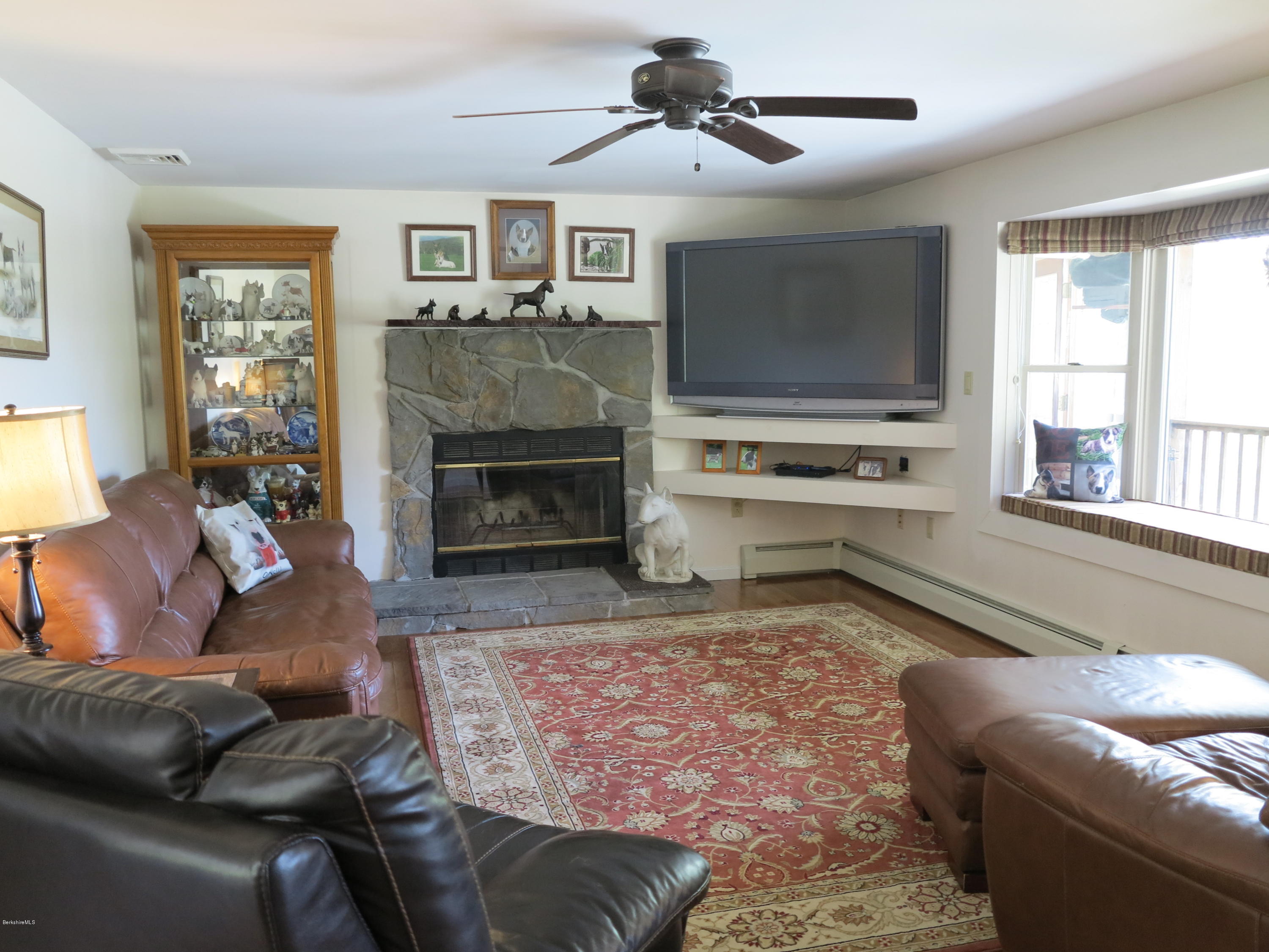 181 Bunce Road South Sheffield, MA 01222 - Photo 6 of 22 a living room with furniture flat screen tv and a fireplace