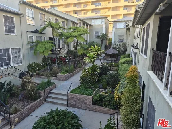 a view of a garden filled with potted plants