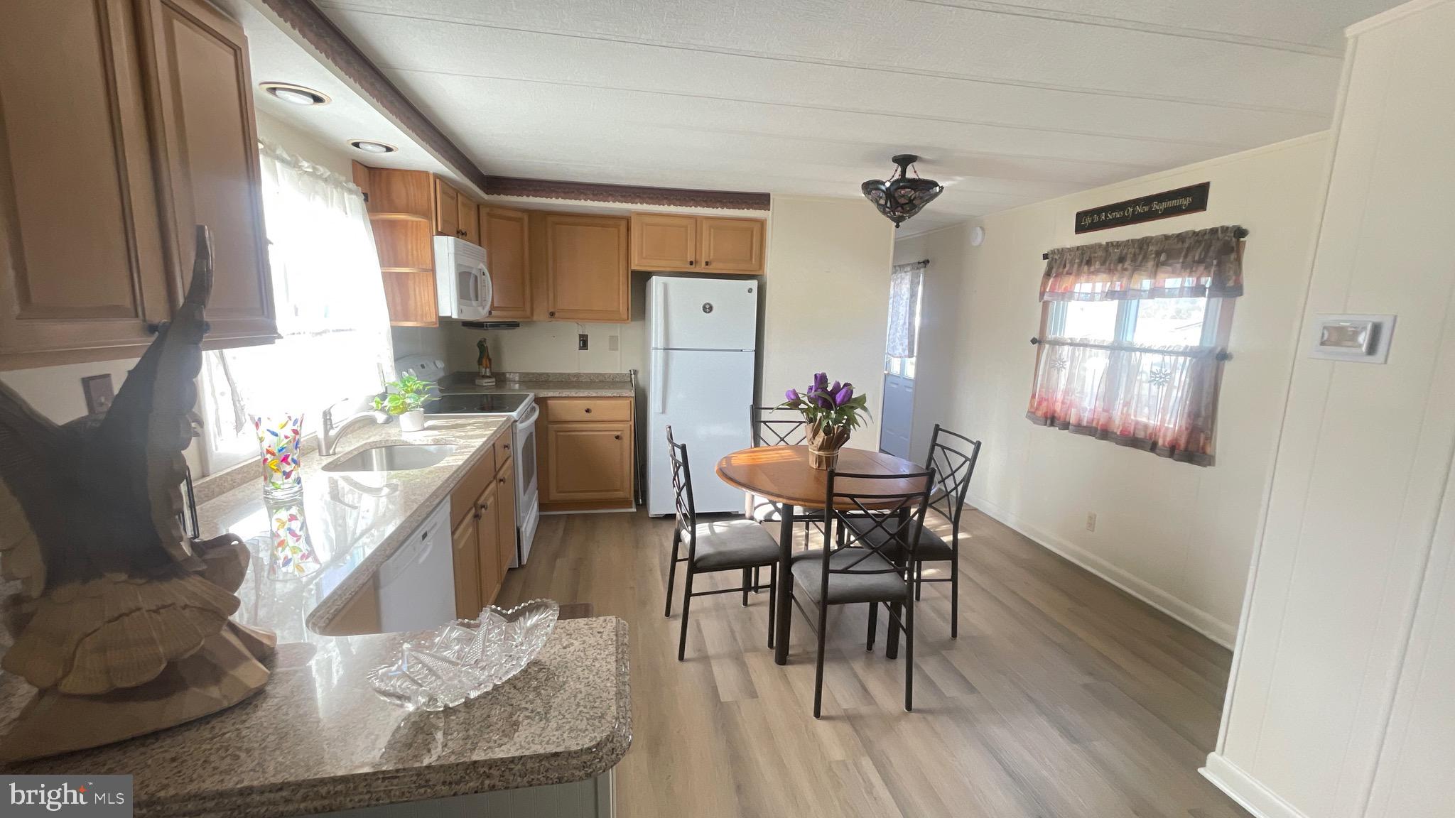 461 Running Brook Road North Wales, PA 19454 - Photo 11 of 19 a kitchen with granite countertop kitchen island stainless steel appliances a dining table and chairs