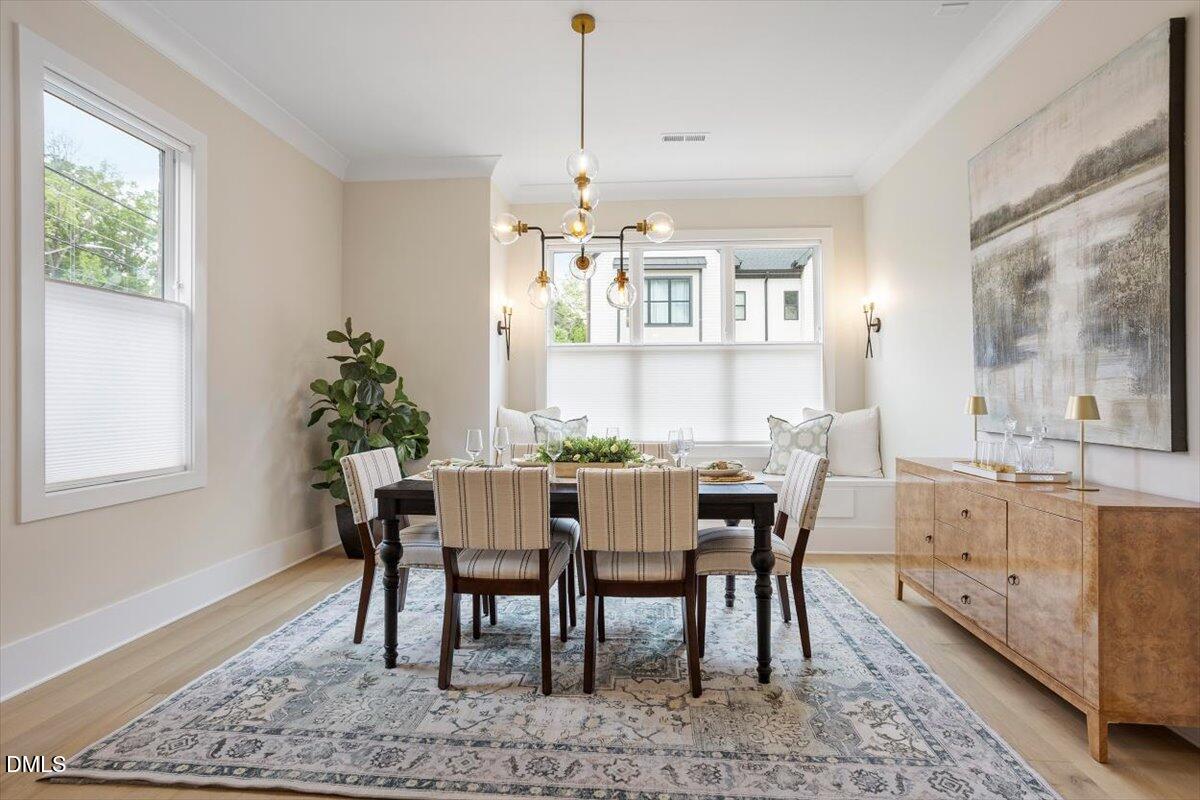 811 Maple Berry Lane, Unit 101 Raleigh, NC 27607 - Photo 12 of 45 a view of a dining room with furniture window and wooden floor