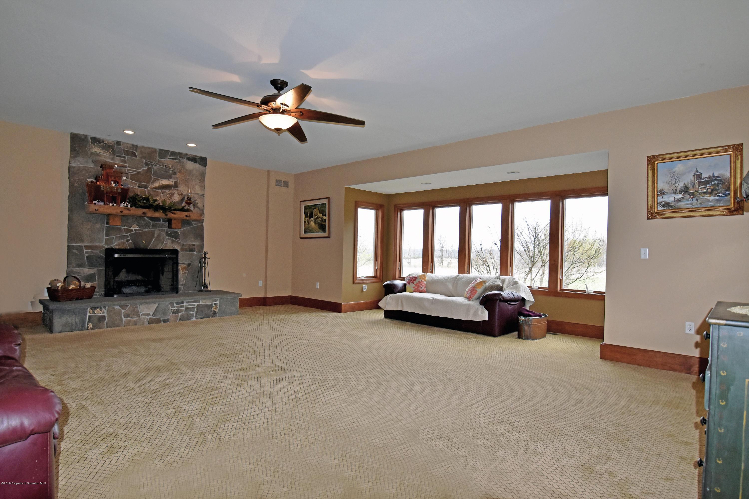 505 Spadine Road Nicholson, PA 18446 - Photo 11 of 38 a view of livingroom with furniture fireplace and a window