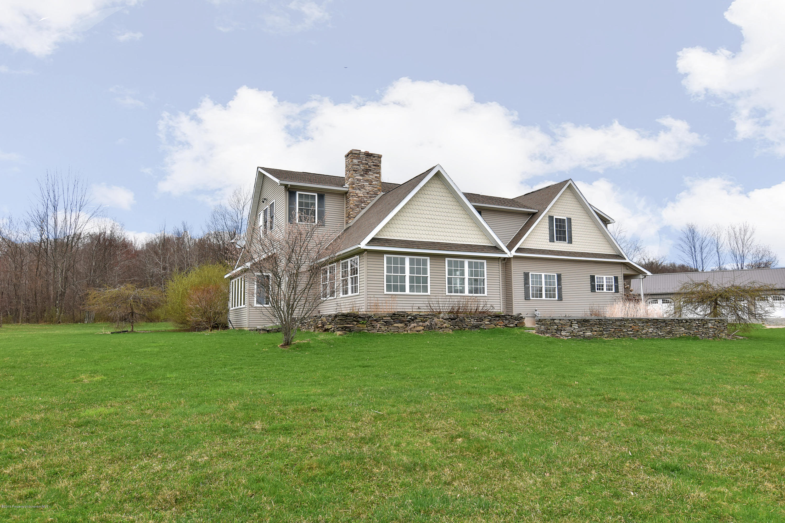 505 Spadine Road Nicholson, PA 18446 - Photo 3 of 38 a view of a house with a big yard and large trees