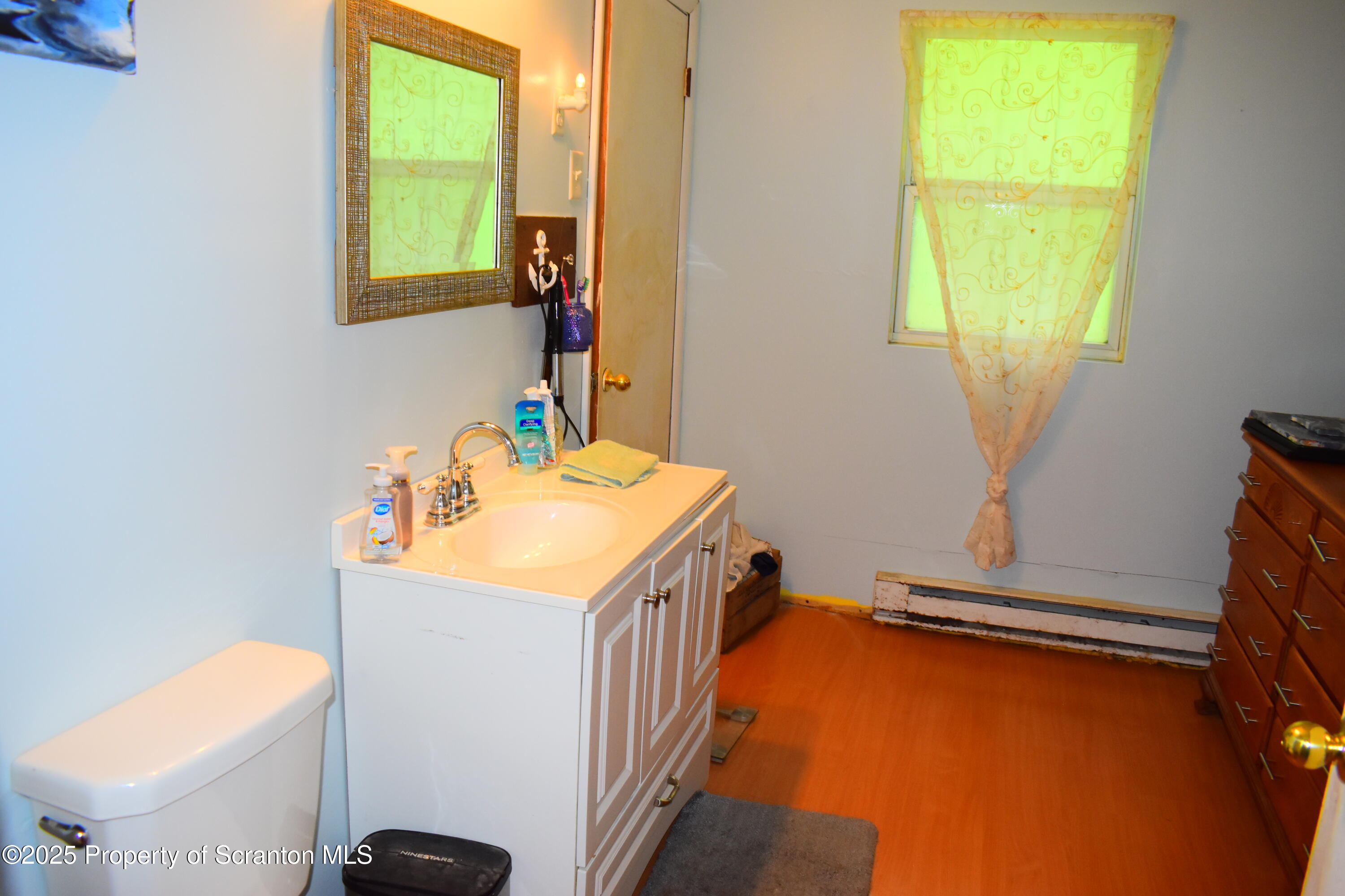760 State Rte 3021 Springville, PA 18844 - Photo 13 of 26 a bathroom with a sink a toilet and a window