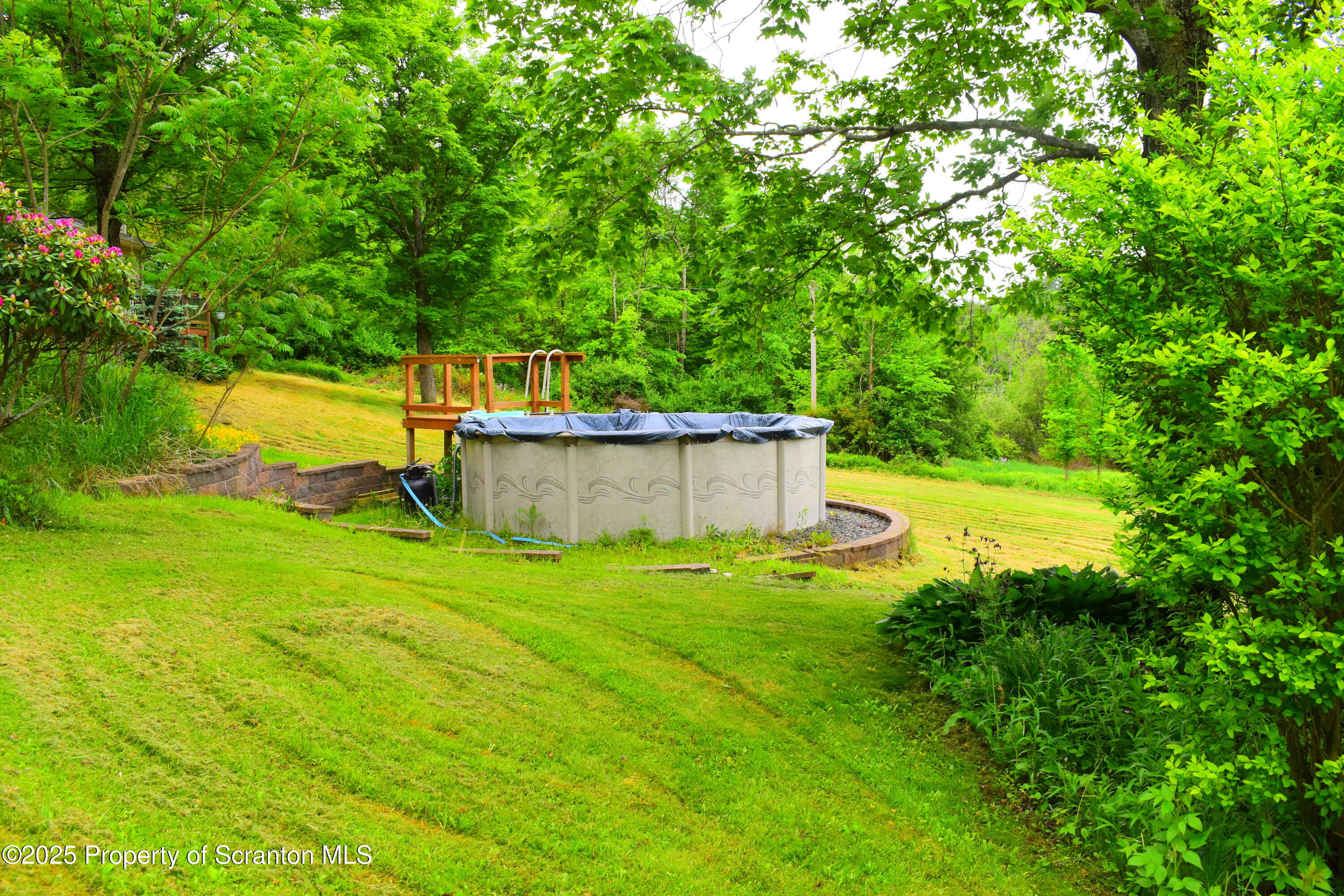 760 State Rte 3021 Springville, PA 18844 - Photo 3 of 26 a backyard of a house with trees and outdoor seating