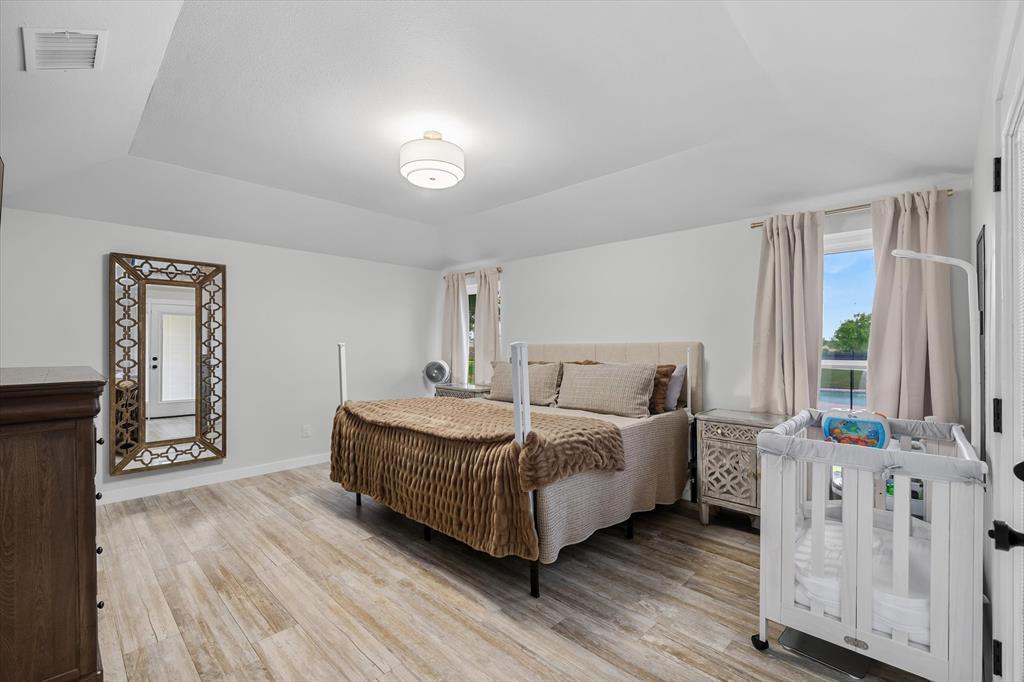 9346 Homestead Lane Forney, TX 75126 - Photo 12 of 39 The large primary bedroom provides a neutral color palette and design detail to align with any style decor -- freshly painted and with updated lighting.