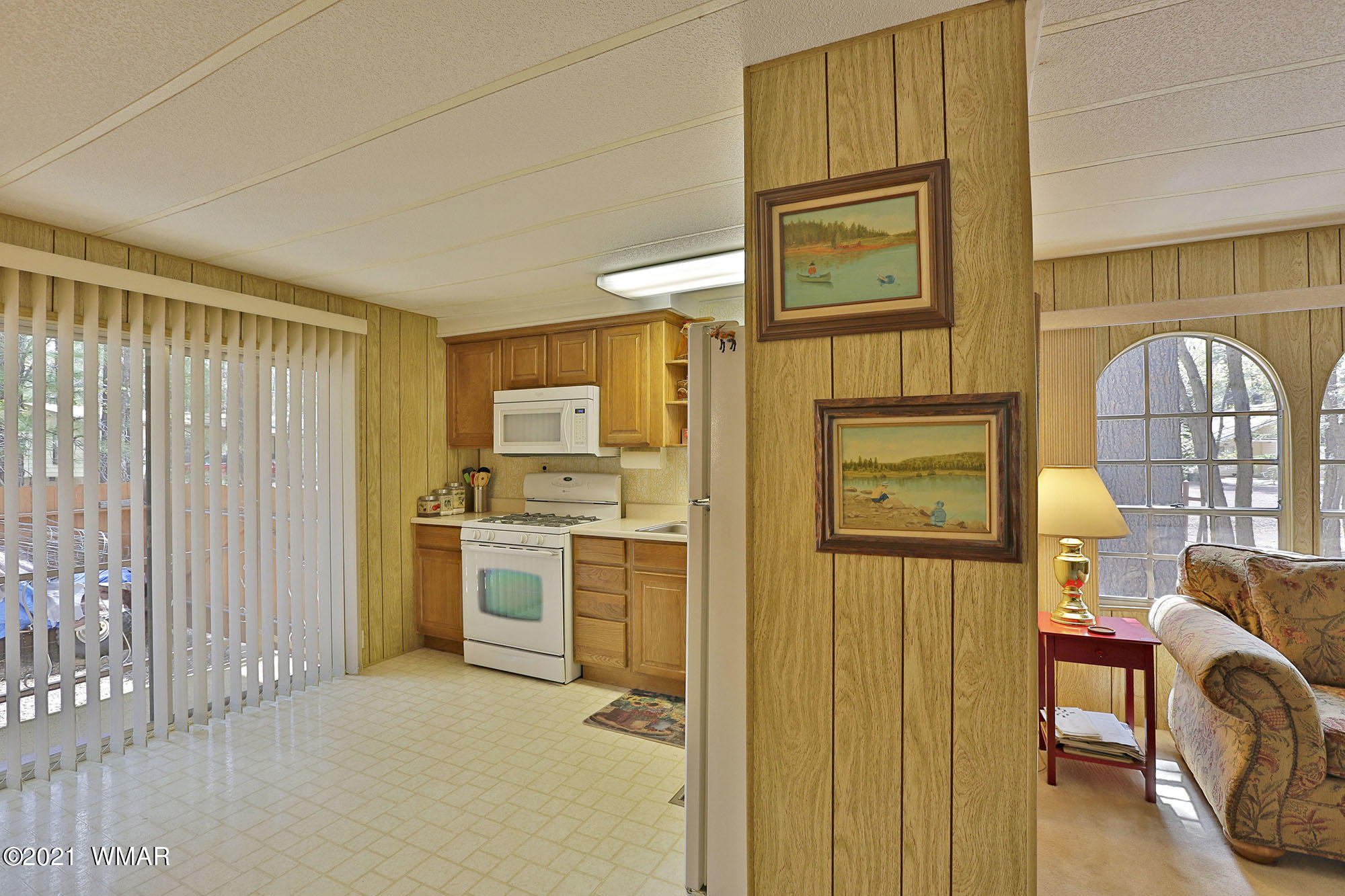 4308 Racoon Court Pinetop, AZ 85935 - Photo 8 of 14 a view of a kitchen with a refrigerator cabinets and a wooden floor