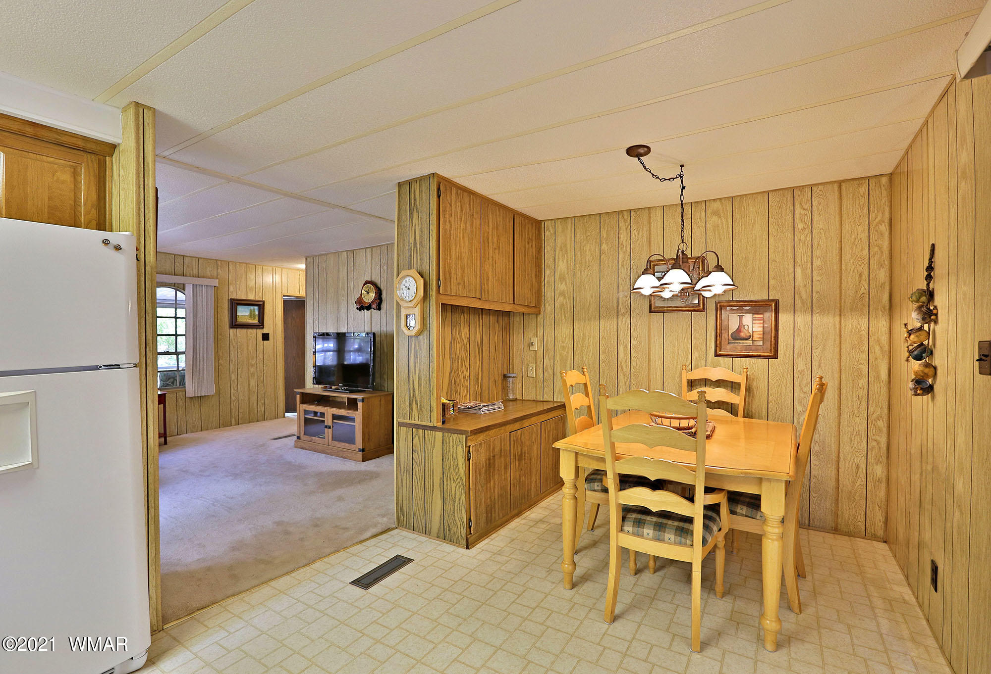 4308 Racoon Court Pinetop, AZ 85935 - Photo 10 of 14 a view of a dining room with furniture and chandelier