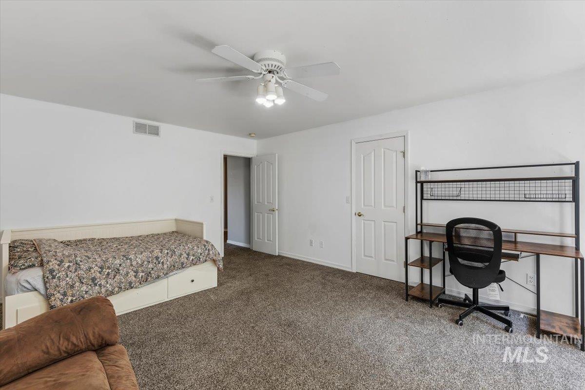 8001 West Innsbrook Court Boise, ID 83704 - Photo 25 of 39 Spacious room featuring neutral carpeting, white walls, and a ceiling fan with integrated lighting