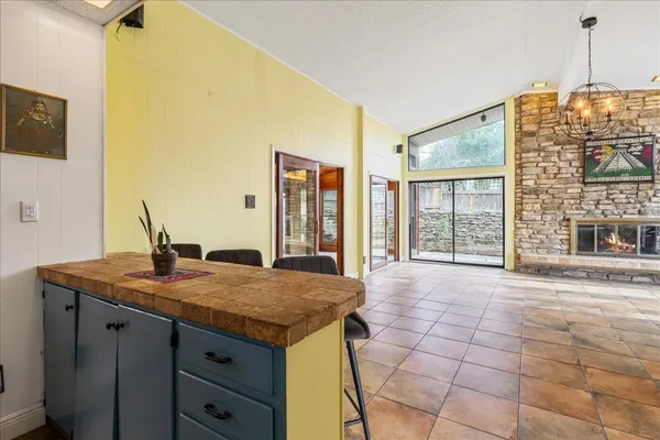 a kitchen with granite countertop a sink cabinets and wooden floor