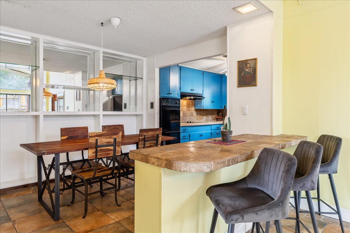 209 Finn Street Austin, TX 78734 - Photo 12 of 40 Breakfast bar accross from dining space with custom shelving