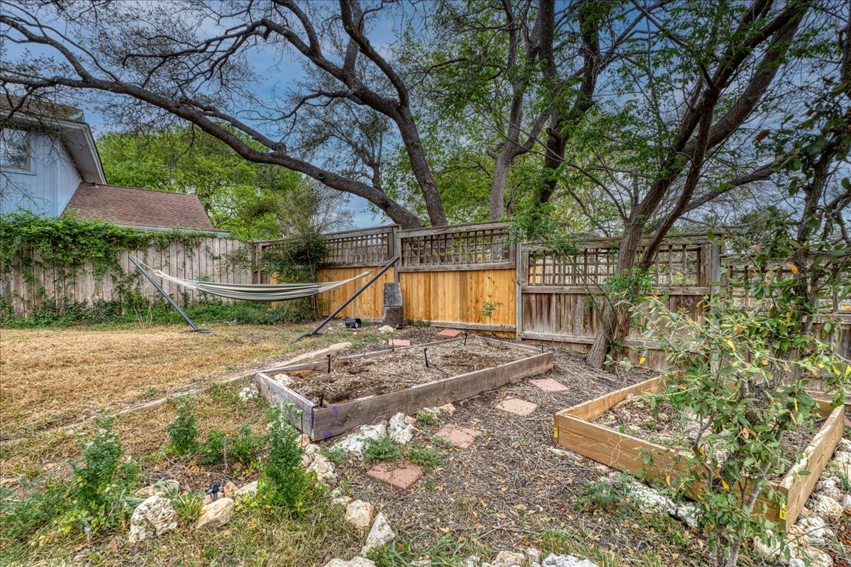 209 Finn Street Austin, TX 78734 - Photo 25 of 40 View of yard with a garden and fence