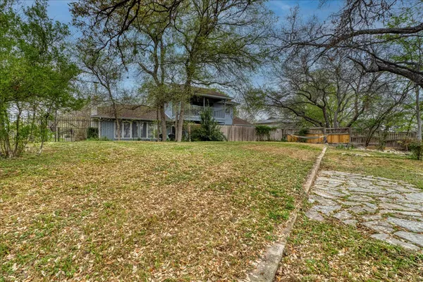 a view of a backyard with large trees