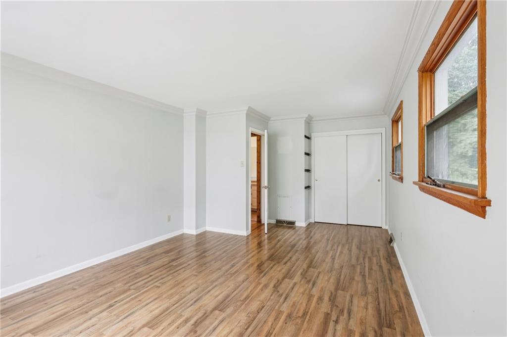 3425 Mercer Road New Castle, PA 16105 - Photo 15 of 38 a view of an empty room with wooden floor and a window