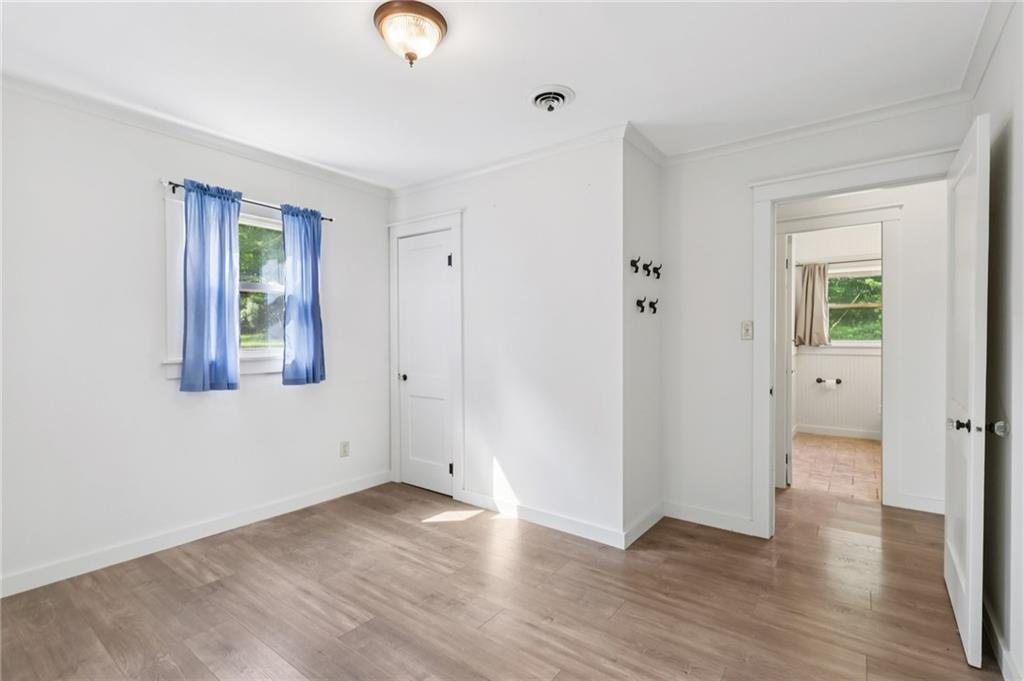 3425 Mercer Road New Castle, PA 16105 - Photo 22 of 38 an empty room with wooden floor and windows